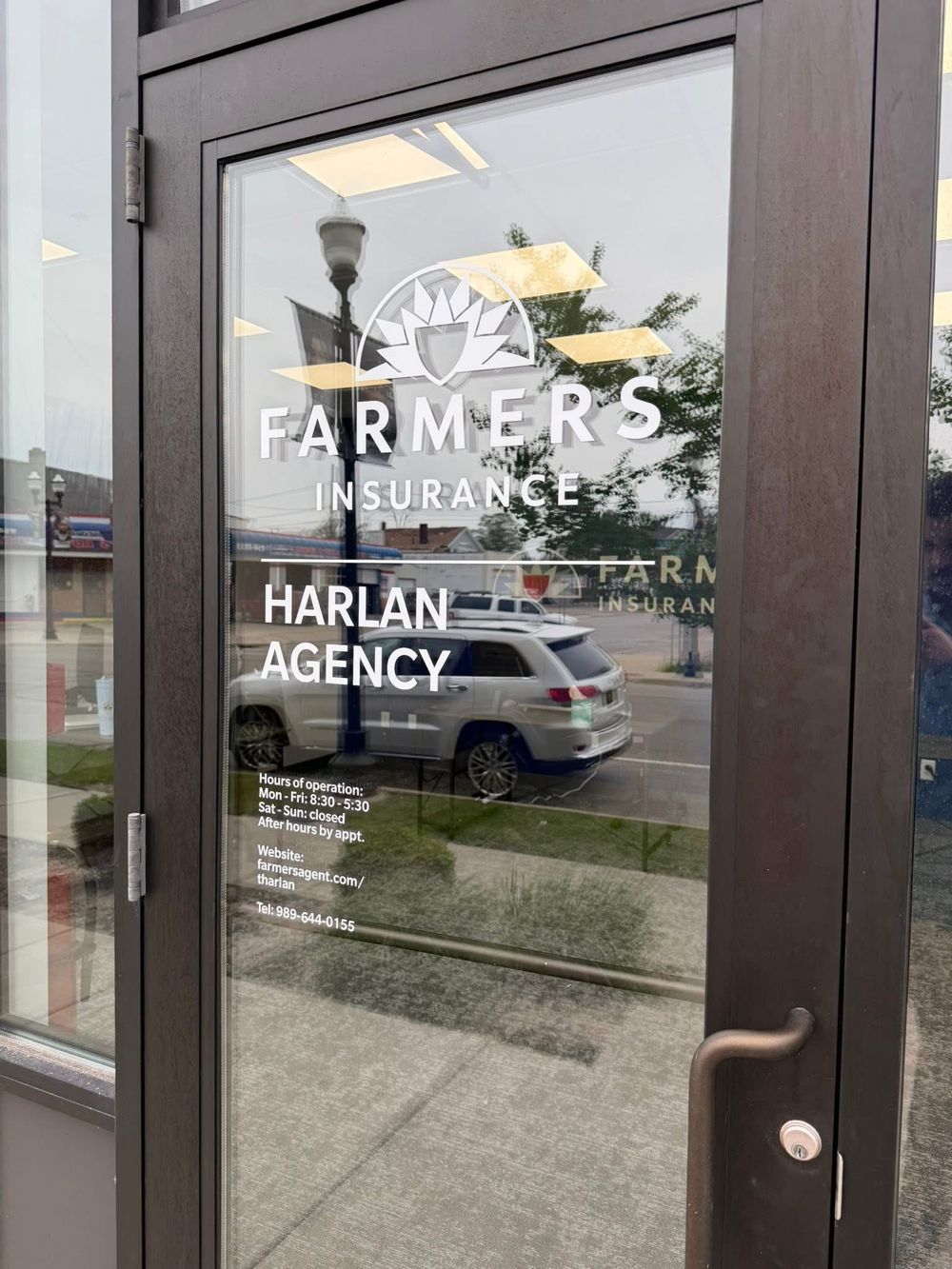 Farmers Insurance Harlan Agency office door at 314 N Hamilton St Suite 102, Saginaw, MI, showing office hours
