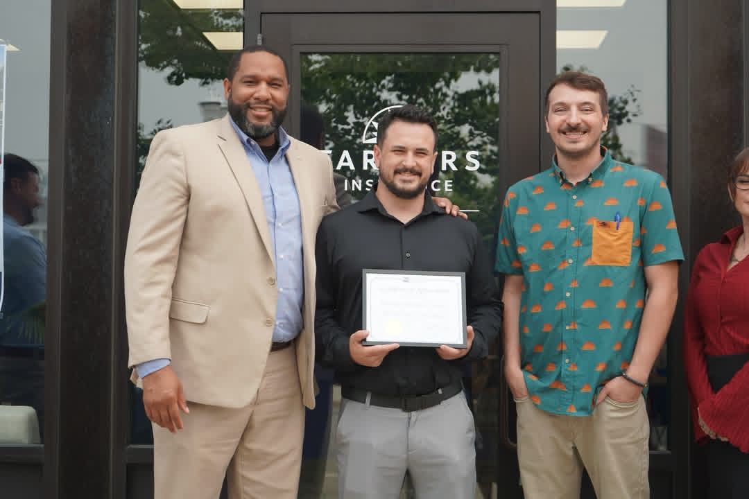 Harlan Insurance Agency team accepting a certificate at the Old Town Saginaw grand opening